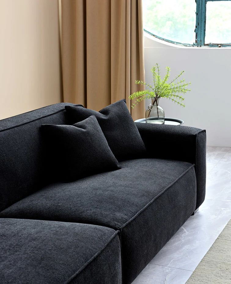 The Alaric 4 Seater Chaise Sofa in Mignight Boucle