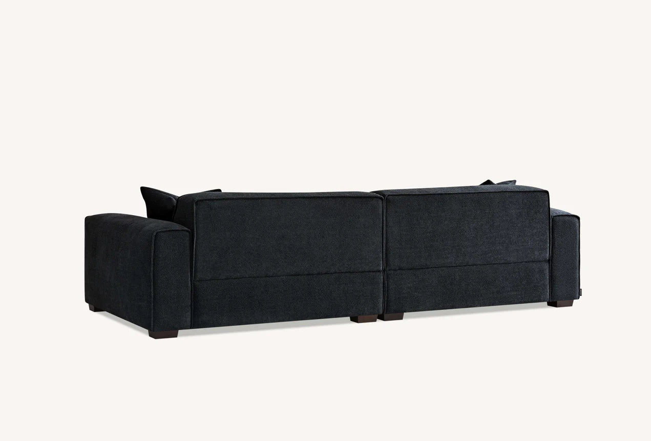 The Alaric 4 Seater Chaise Sofa in Mignight Boucle